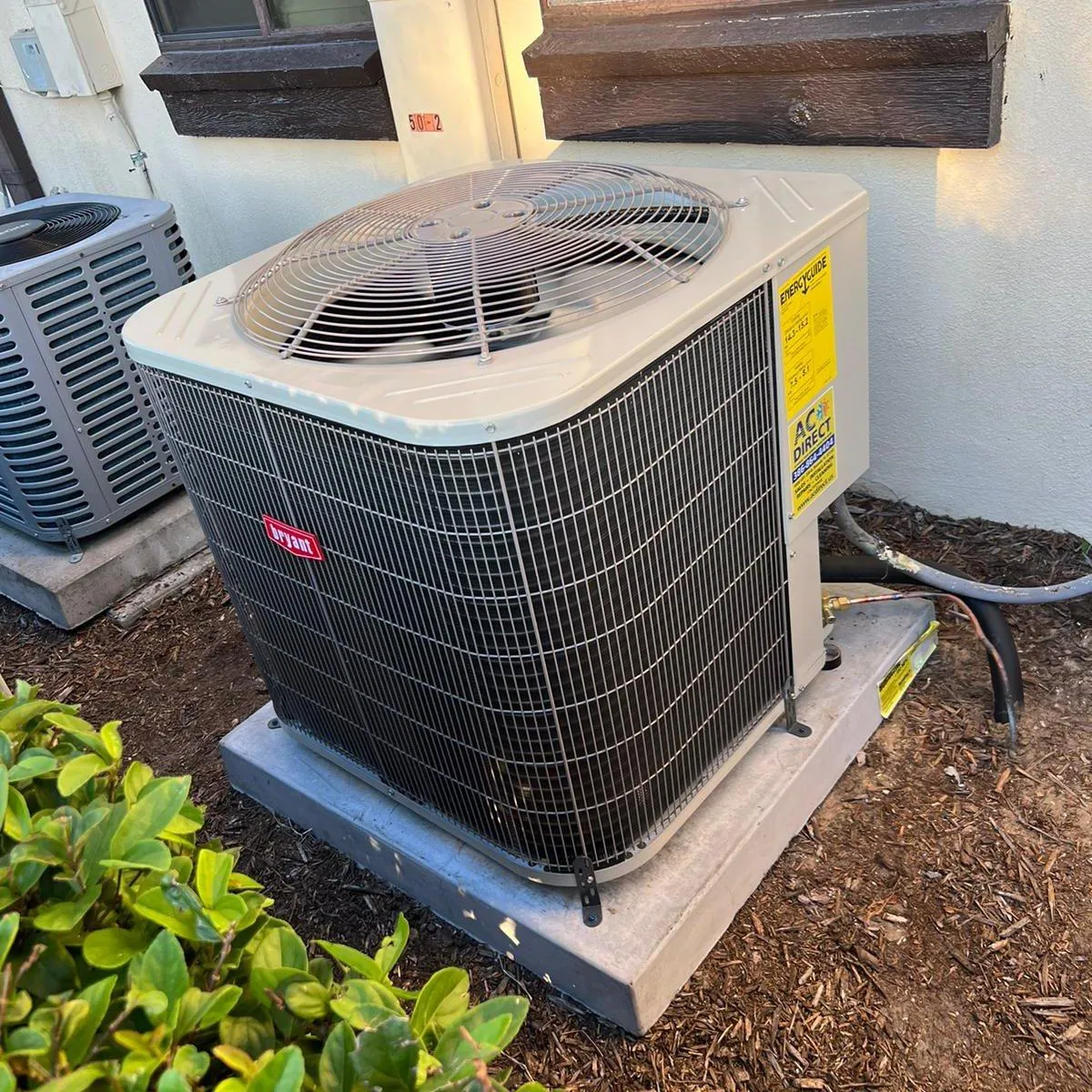 Technician working on a residential central air conditioner